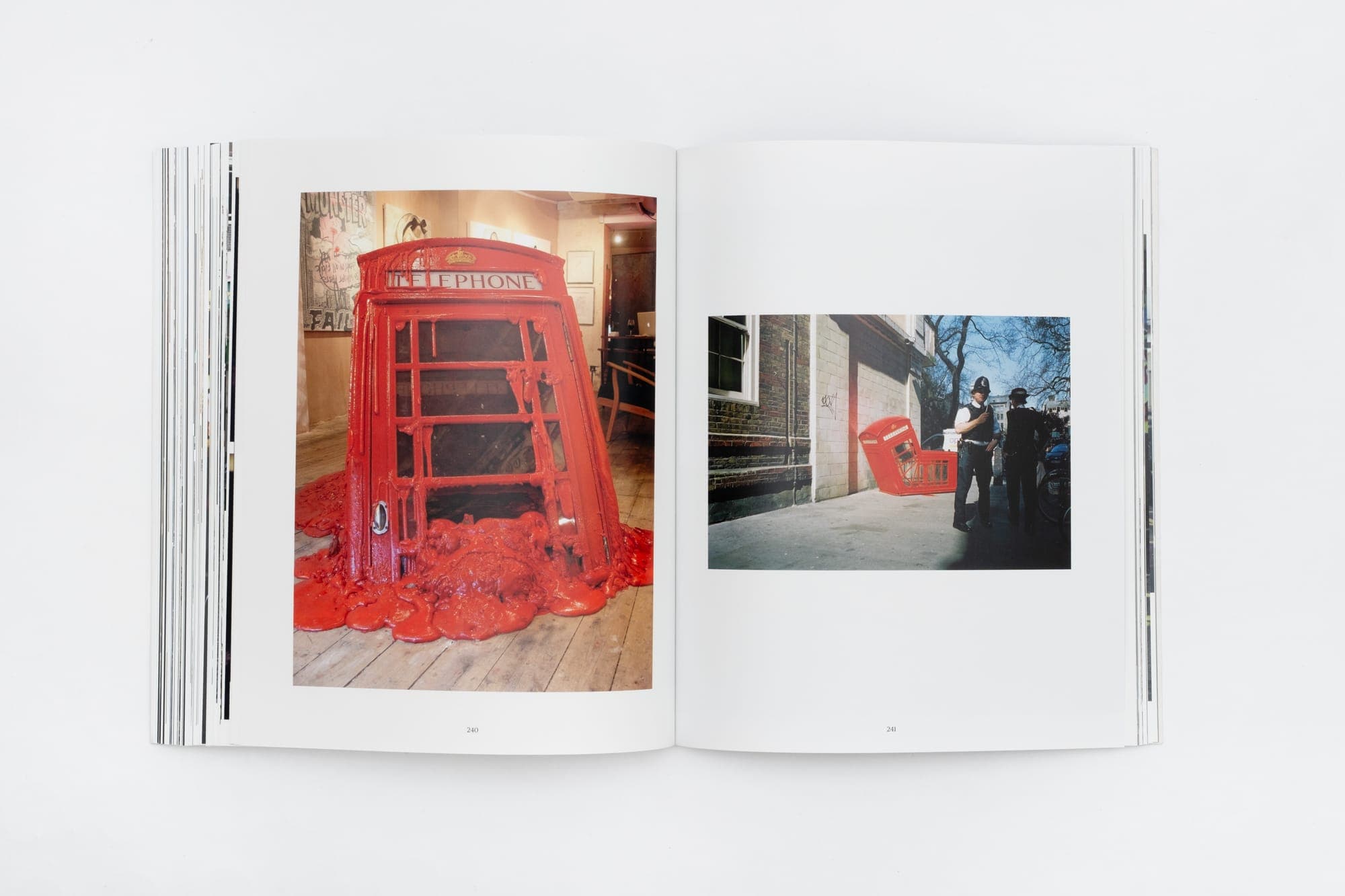 Spread — a red phone box street scene, from Banksy Captured