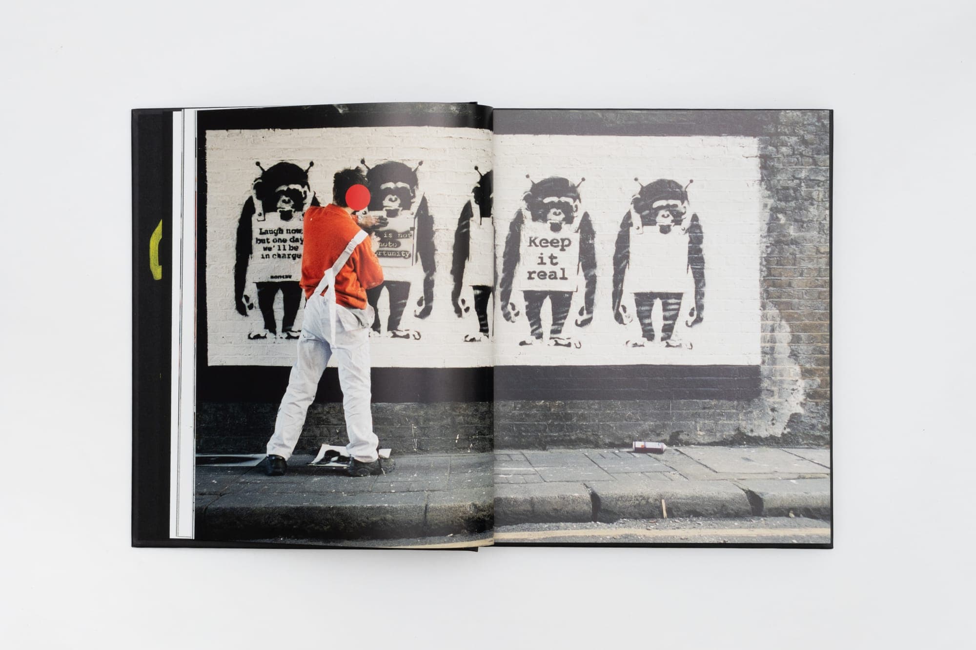 Spread — a row of stencilled figures, from Banksy Captured