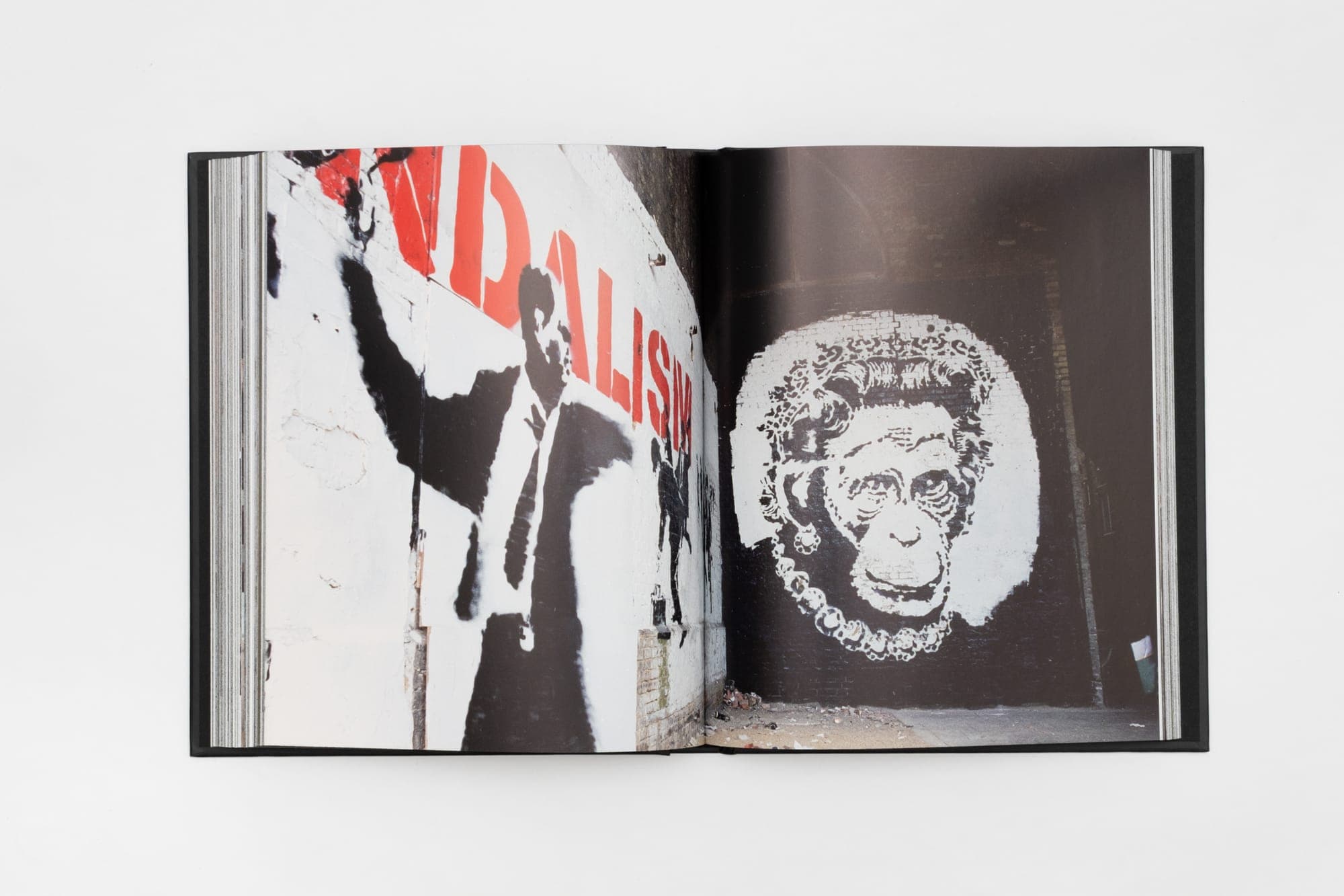 Interior spread printed against deep red, from Banksy Captured