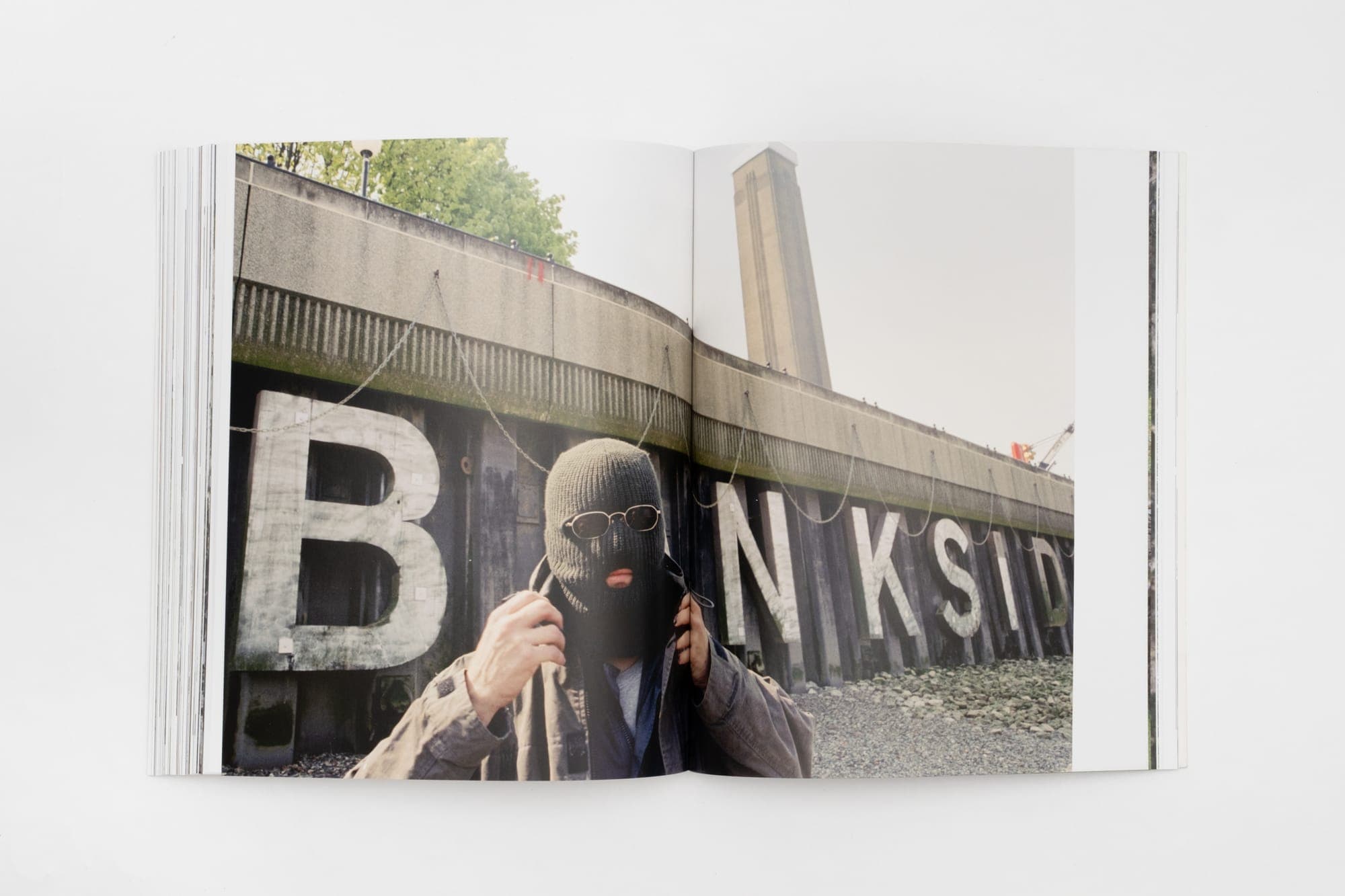 A spread of a large 'BANKS!' street sign, from Banksy Captured